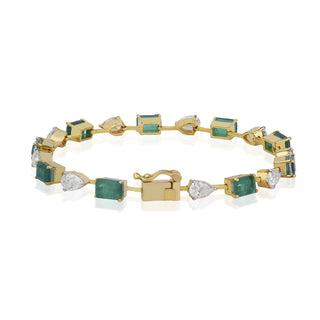 Gold bracelet with green and clear gemstones on a white background