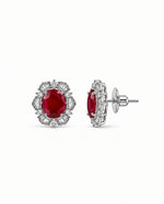 Laal Jharokha Stud Earrings: silver-plated oval studs with a red stone and American diamond baguettes