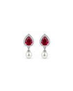 A pair of small, polished silver heart stud earrings on a clean white background with a soft reflection below.