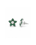 A pair of silver flower stud earrings with green pavé stones and a central white pearl, shown on a plain white background.