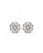 A pair of silver-toned stud earrings featuring a circular floral design set with clear baguette and round-cut gemstones, displayed on a clean white background.