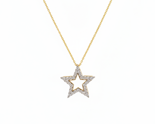 Star-shaped pendant necklace on a gold chain against a white background